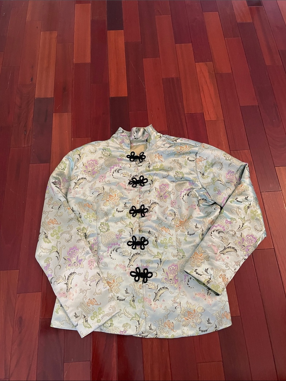 Light green mandarin style collar jacket with black frog buttons